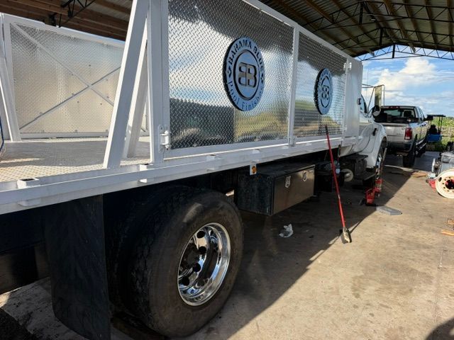 A Bendix brake chamber mounted to a vehicle suspension assembly, with a jack stand visible underneath.