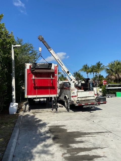A white truck with a crane attached to it