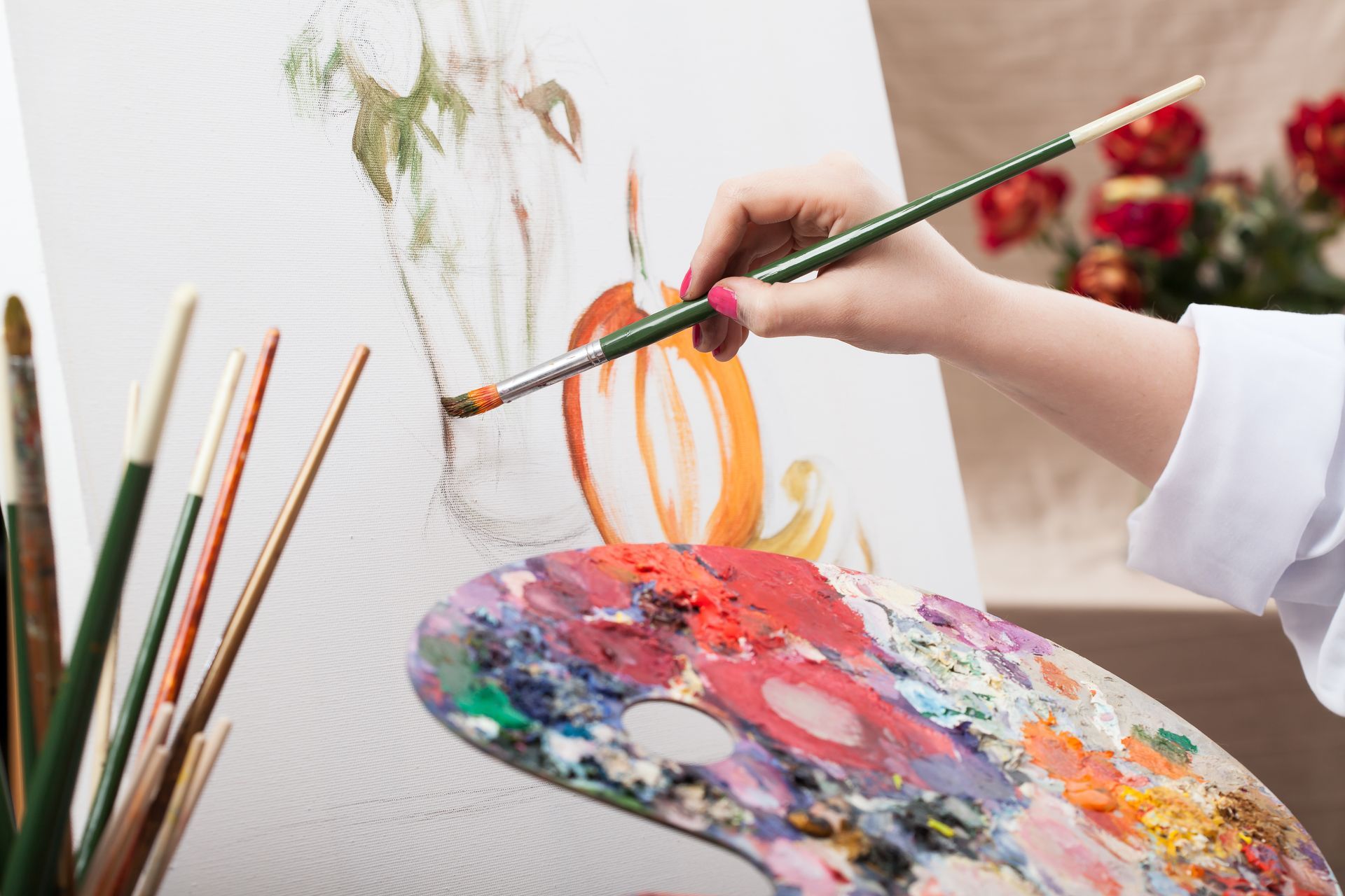 A person is painting on a canvas with a brush.