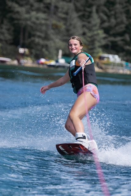 A woman is water skiing on a lake.