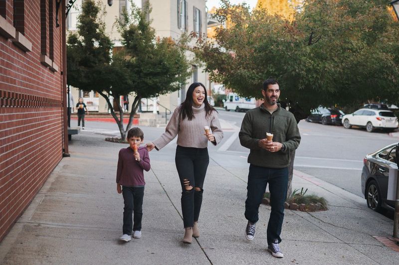 Joy, Evan and their son walking through downtown Nevada City with ice cream cones