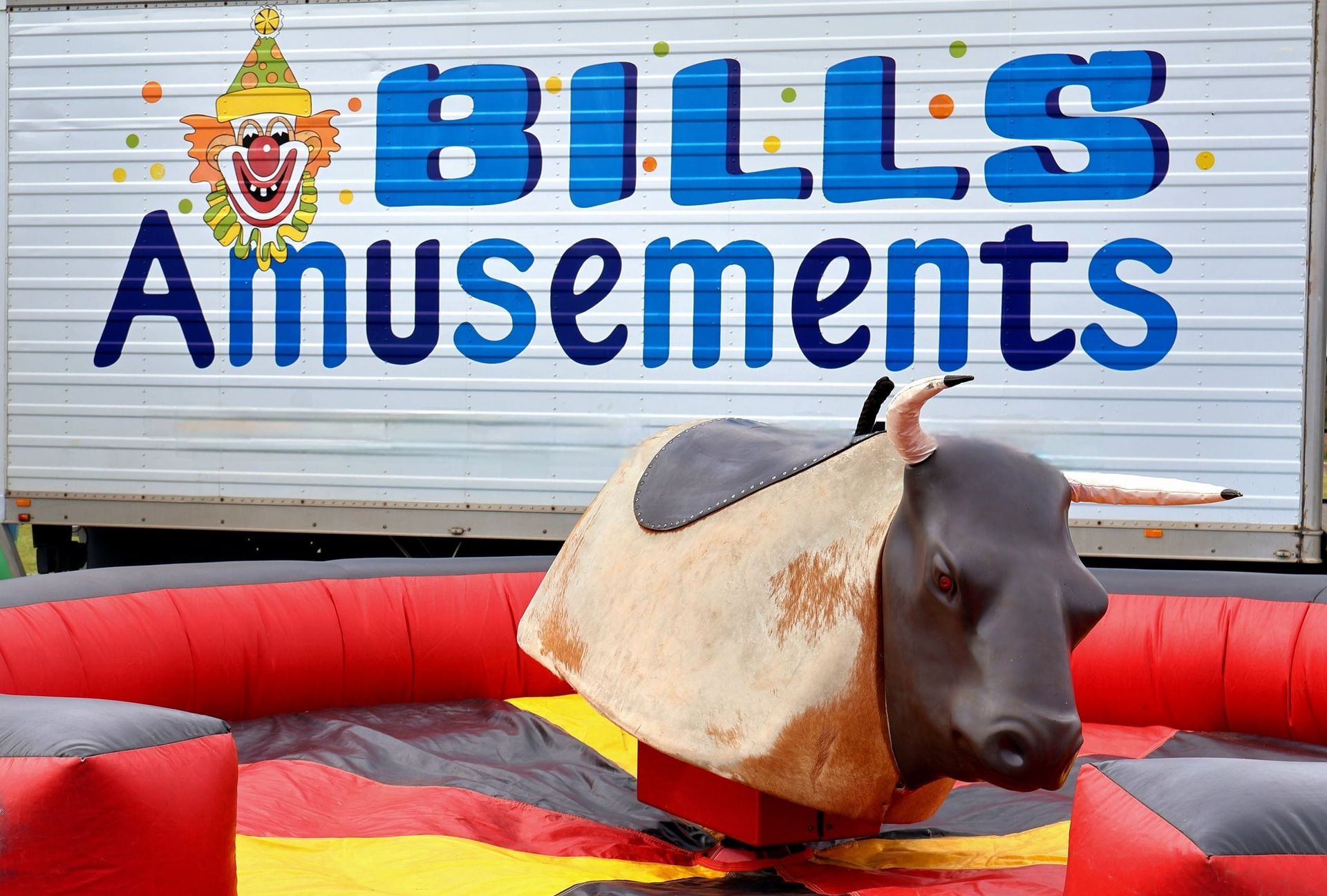 A Mechanical Bull Is Sitting In Front Of A Bills Amusements Sign — Bills Amusements In Mackay, QLD