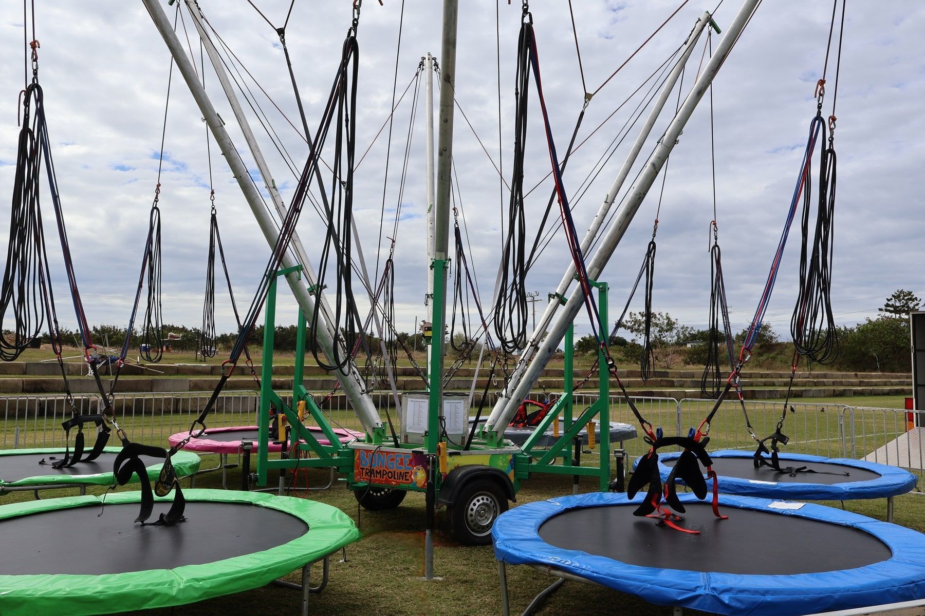 A Group Of Trampolines Are Sitting On Top Of A Grass Covered Field — Bills Amusements In Gladstone, QLD