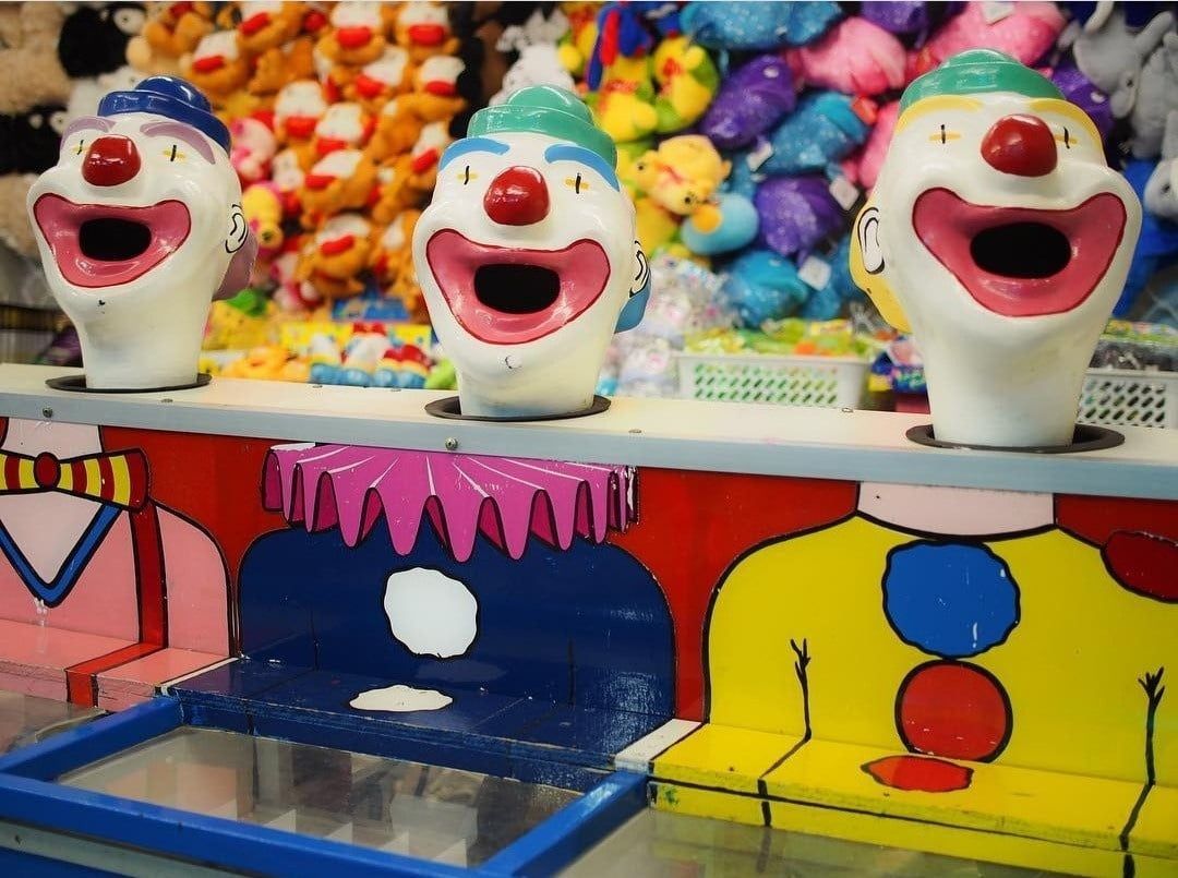 A Row Of Clown Heads With Their Mouths Open — Bills Amusements In Hervey Bay, QLD