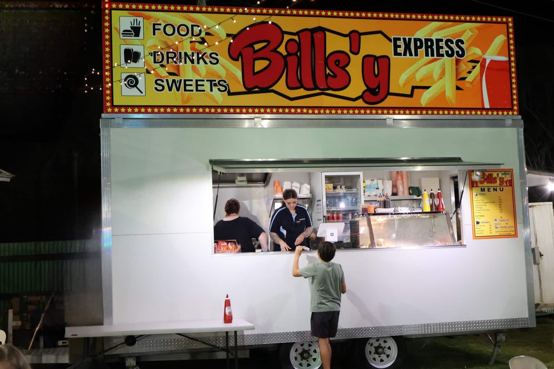 A Boy Standing In Front Of A Billy 's Express Food Truck — Bills Amusements In Gladstone, QLD