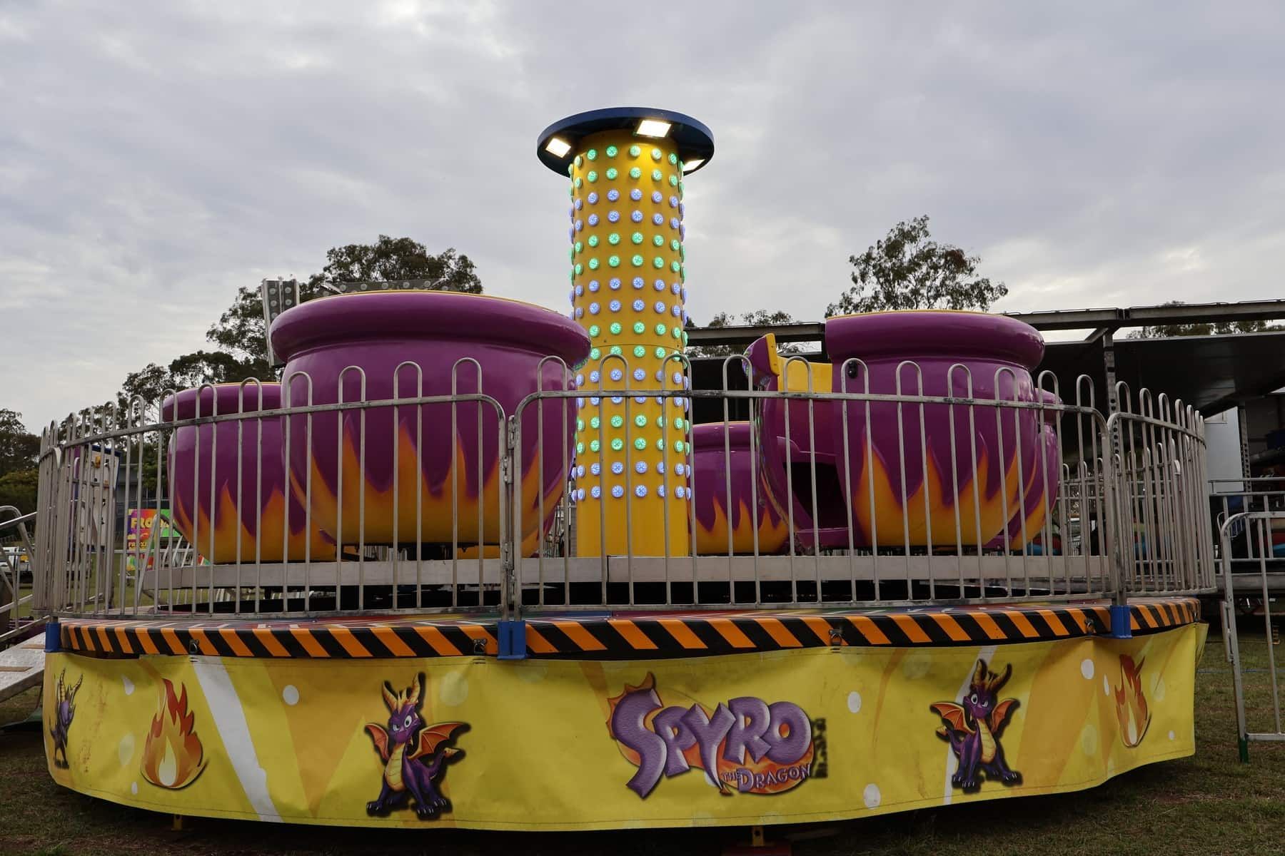 A Yellow And Purple Carnival Ride With The Word Spyro On It — Bills Amusements In Biloela, QLD