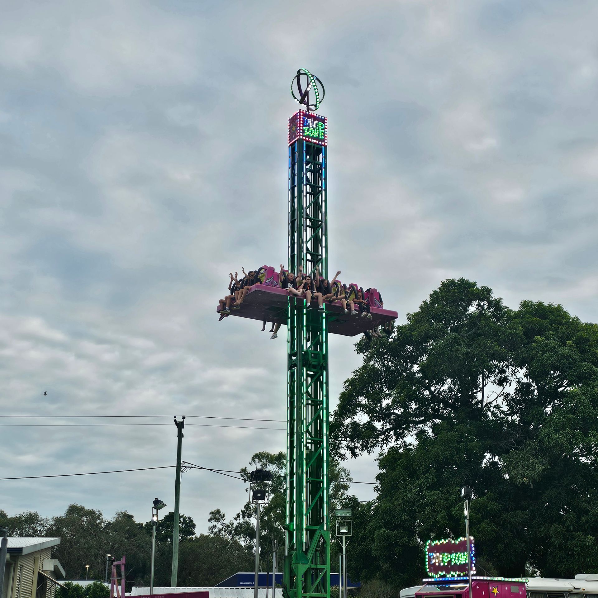 A Group Of People Are Riding A Drop Ride — Bills Amusements In Rockhampton, QLD