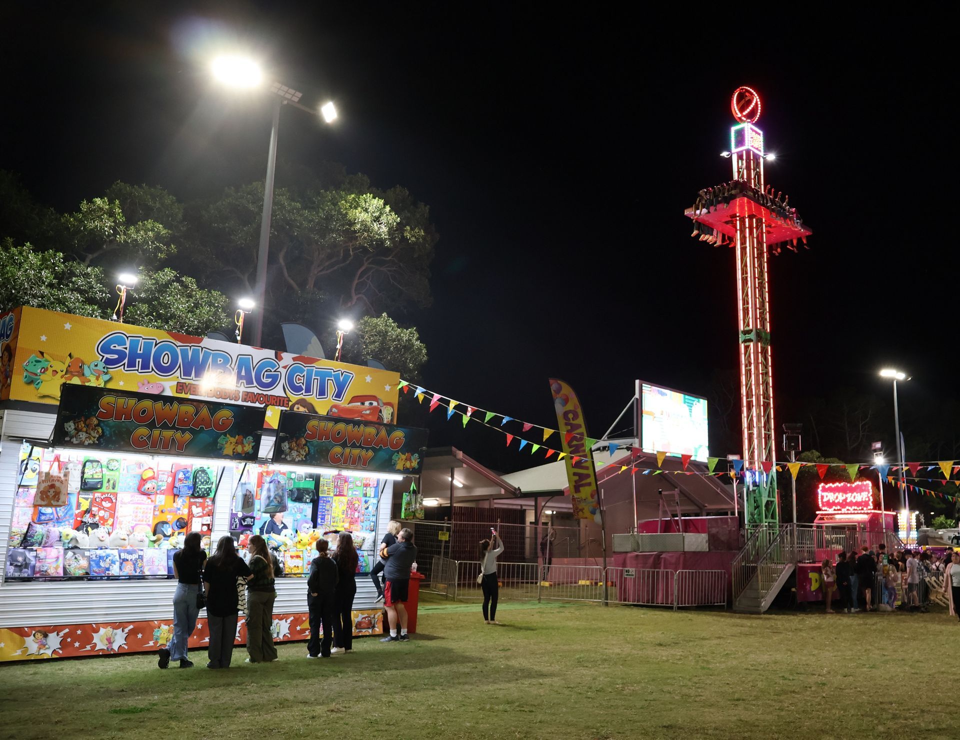 A Group Of People Standing In Front Of A Carnival Ride — Bills Amusements In Rockhampton, QLD