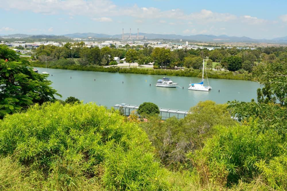 A River With Boats In It And A City In The Background — Bills Amusements In Gladstone, QLD