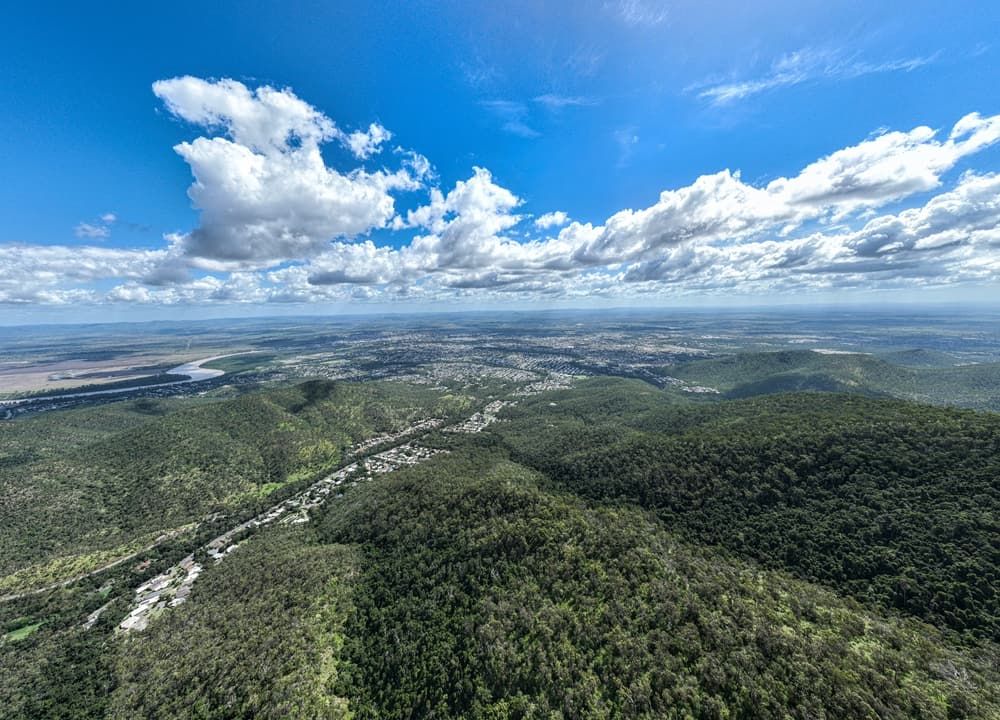 An Aerial View Of A Valley Surrounded By Mountains And Trees — Bills Amusements In Rockhampton, QLD