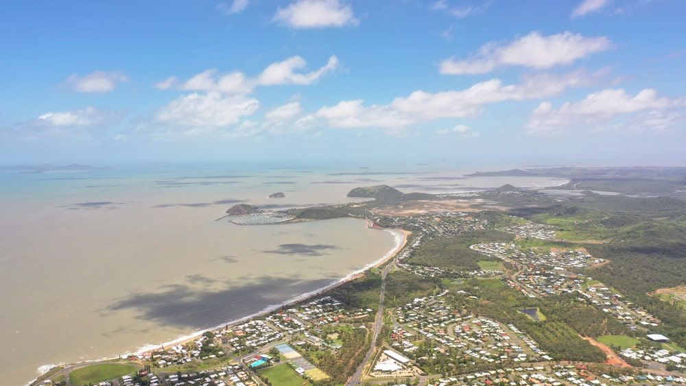 An Aerial View Of A City Next To A Body Of Water — Bills Amusements In Yeppoon, QLD