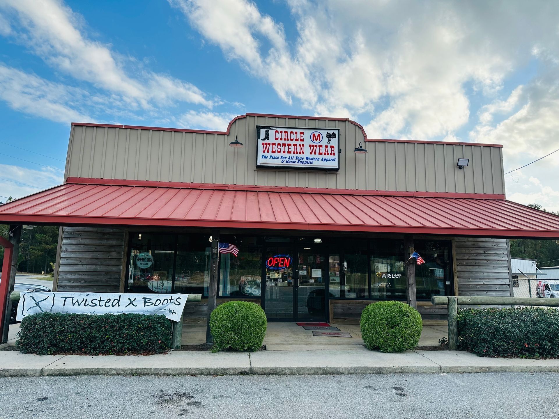 A brown and red building with a sign that reads