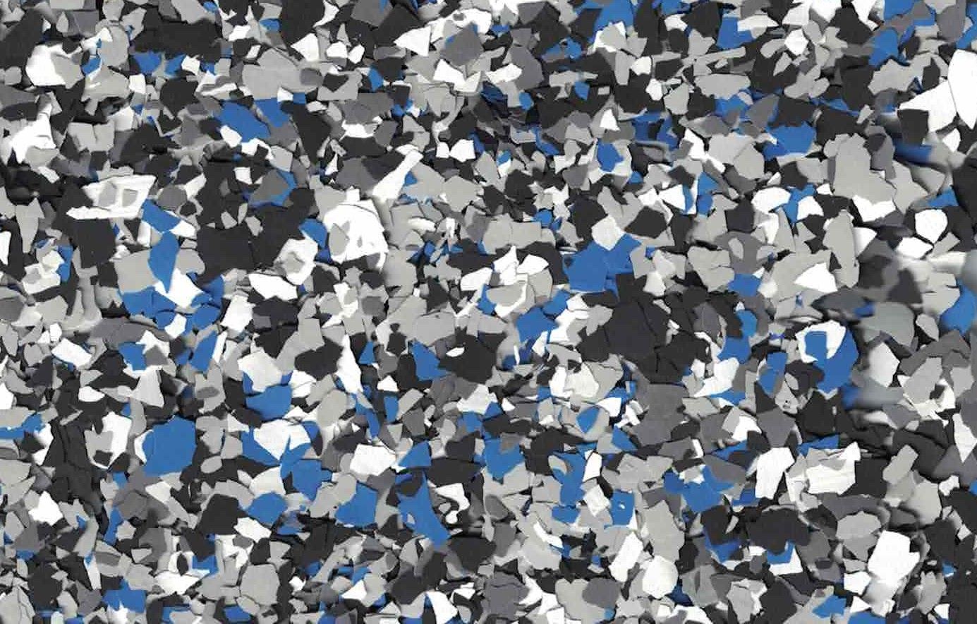 Abstract mosaic of gray, white, and blue geometric shapes scattered across the frame