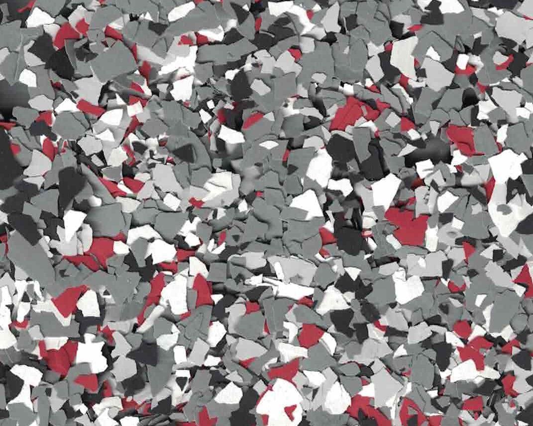 Abstract red, gray, black, and white confetti-like pattern filling the frame.