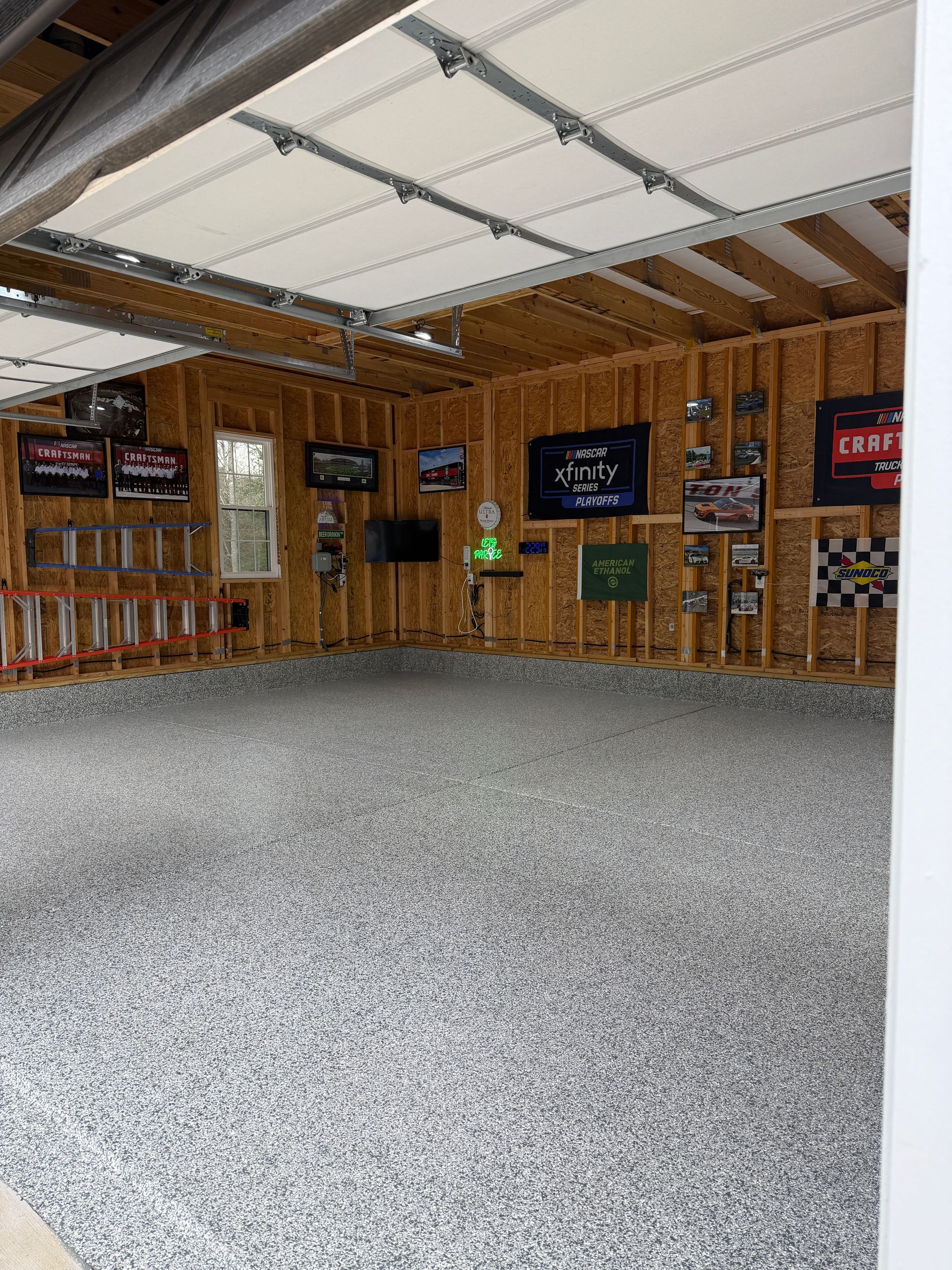 Empty indoor shooting range with wooden walls, overhead roof, and target lanes along the back wall