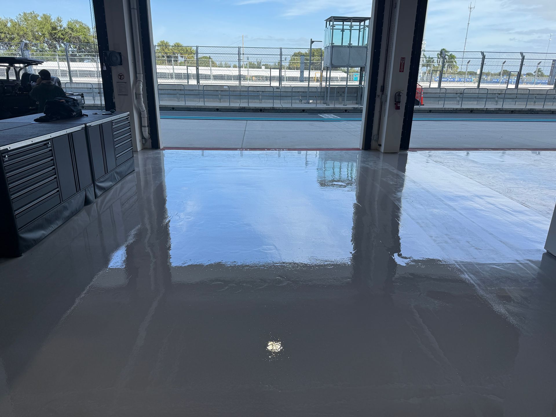 Shiny wet floor reflecting a doorway and outdoor street scene