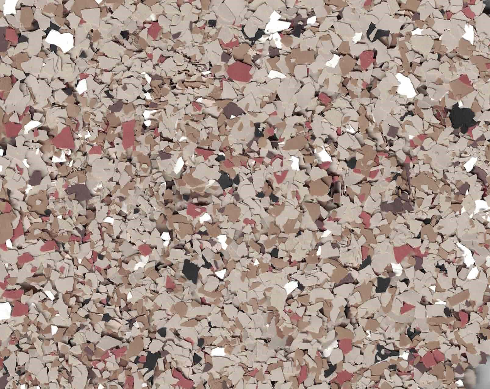 Close-up of a speckled beige, pink, and gray stone or pebble surface texture