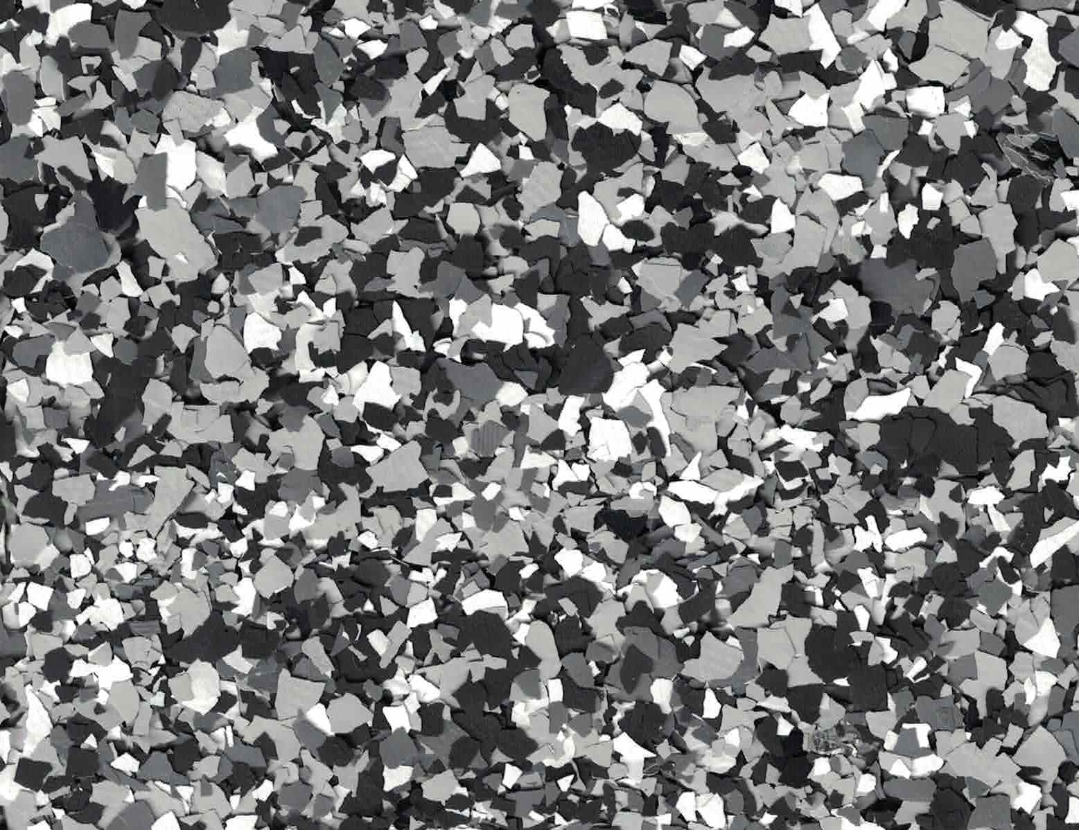 Abstract black, white, and gray camouflage-style pattern of scattered shapes