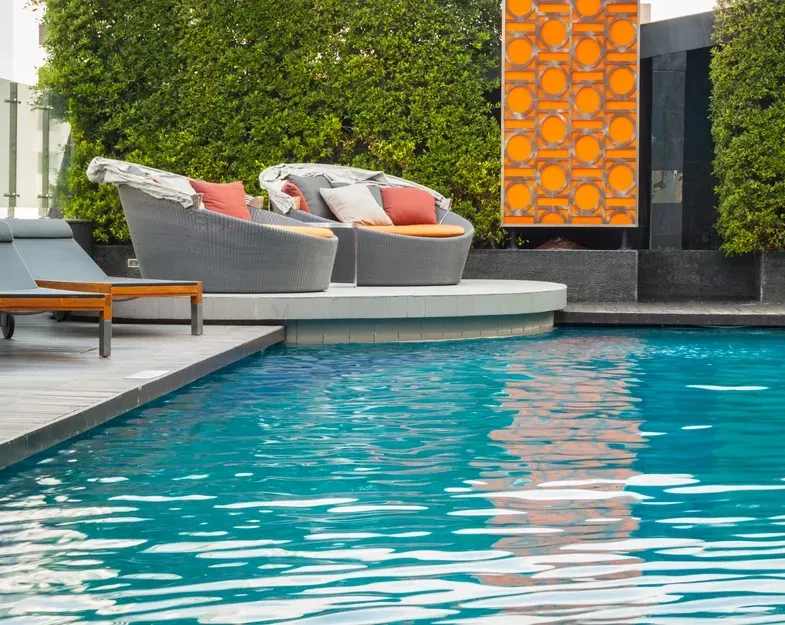Pool with Lounge Chairs and Leafy Hedge Border — Creative Pools and Spas in Mornington, VIC