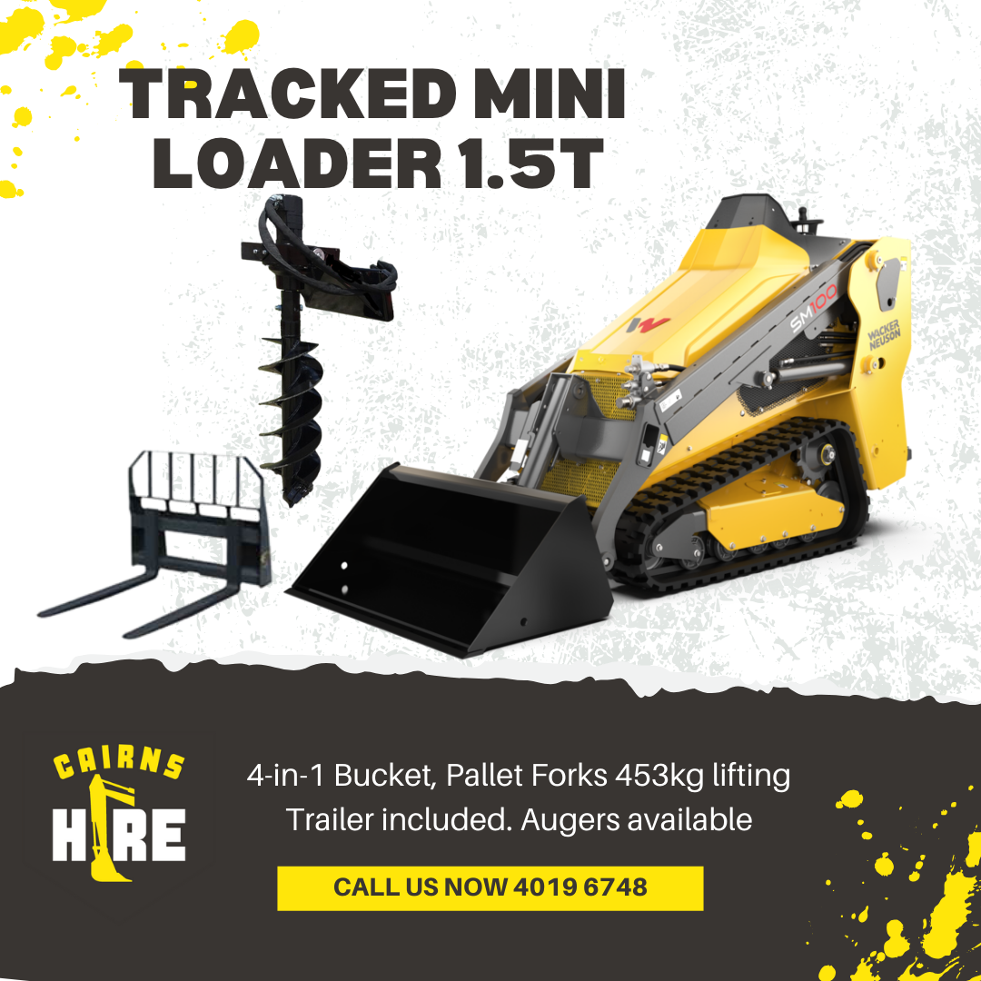 A yellow and black tracked mini loader with a forklift attached to it.