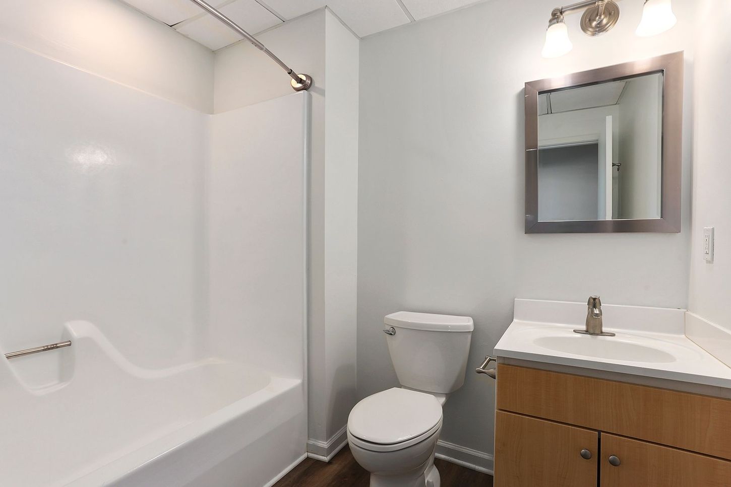 A bathroom with a toilet , sink and bathtub.