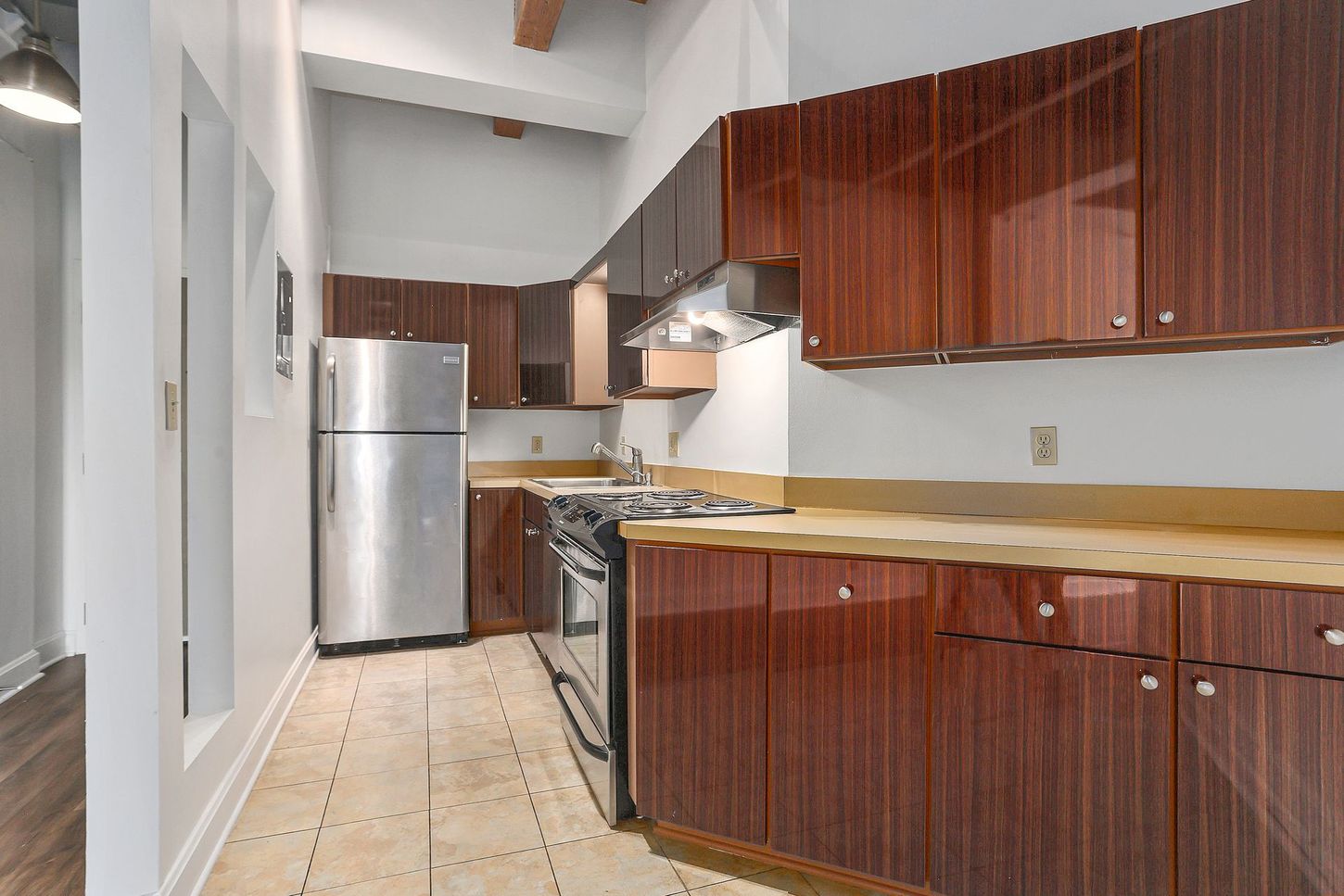 A kitchen with brown cabinets and stainless steel appliances