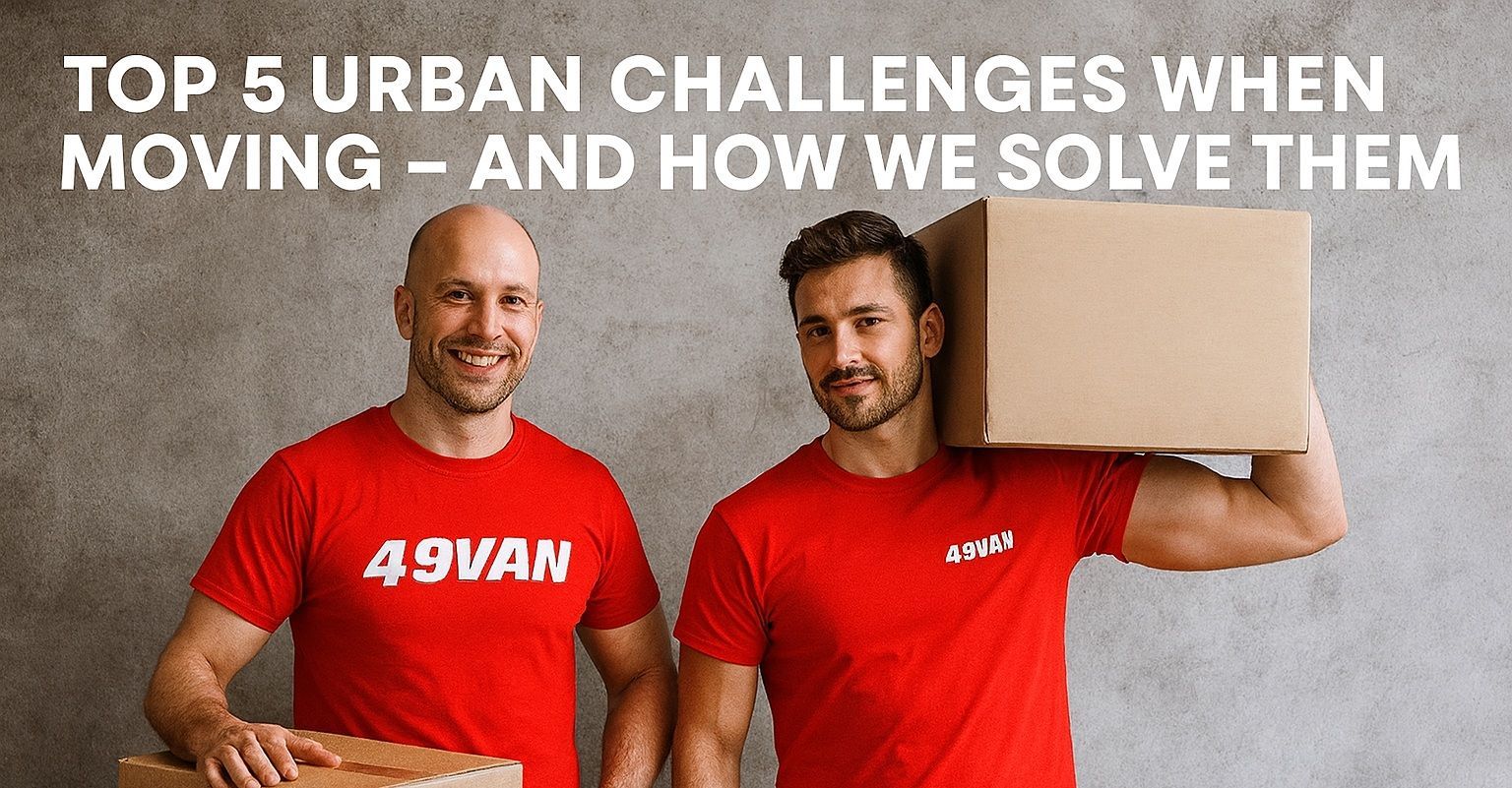 49Van movers in red shirts smile while holding cardboard boxes against a gray urban background wall