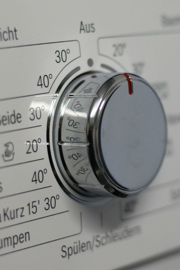 A close up of a knob on a machine that says aus