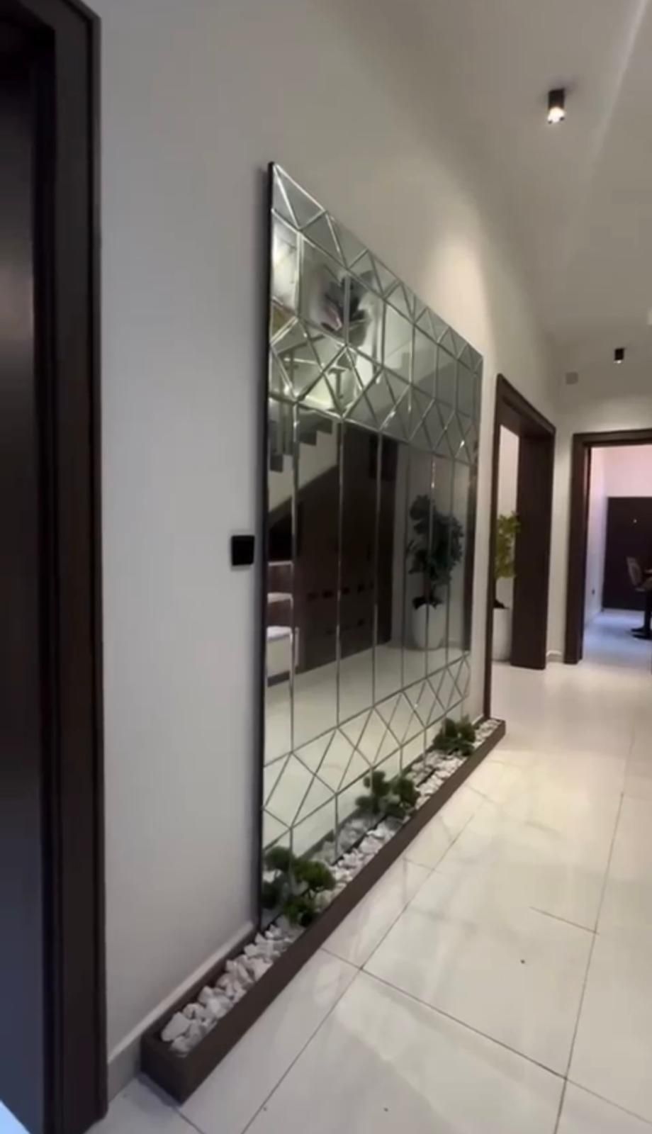 A hallway with a large mirror on the wall