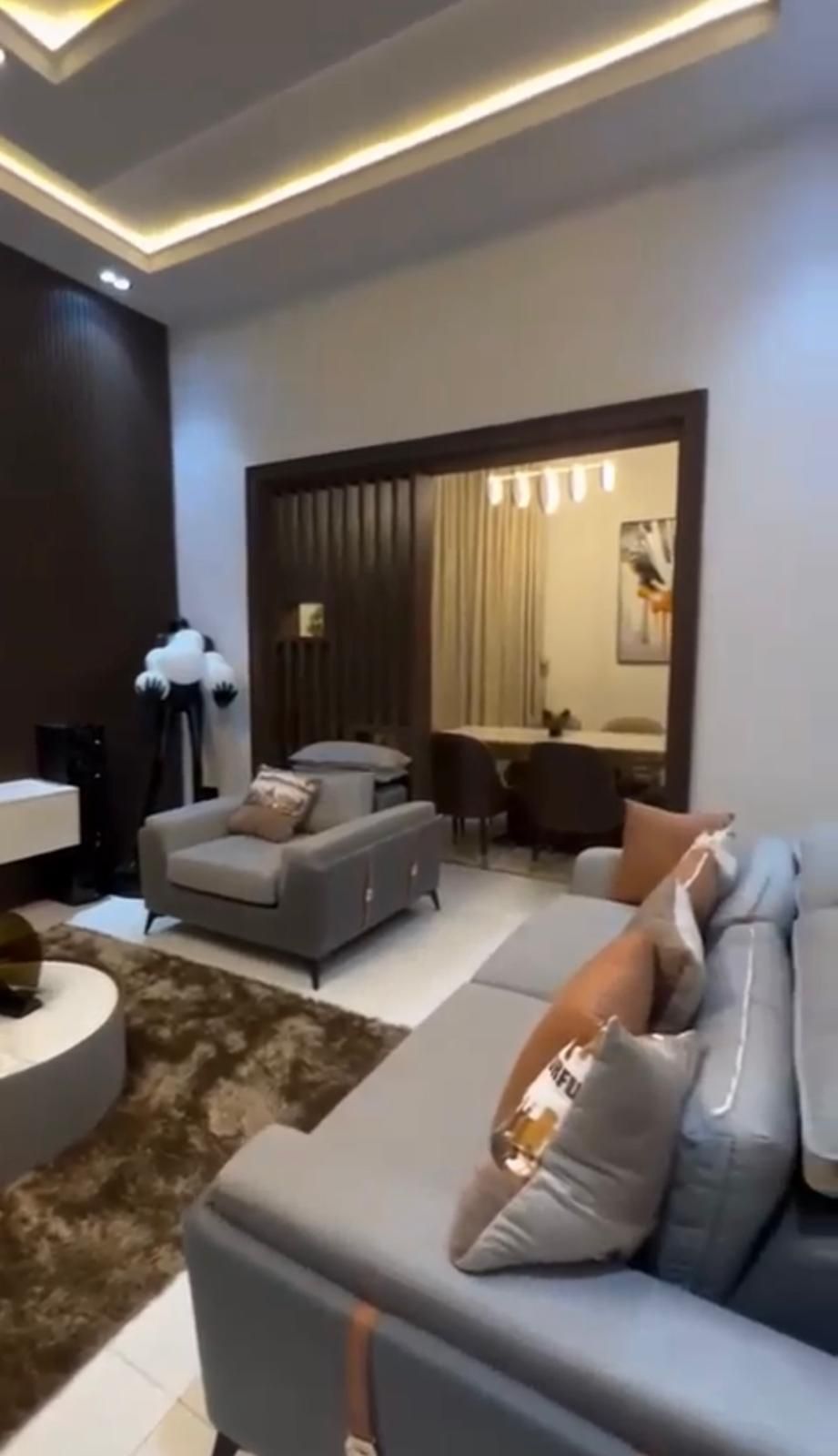 A living room with a couch , chair , table and rug.