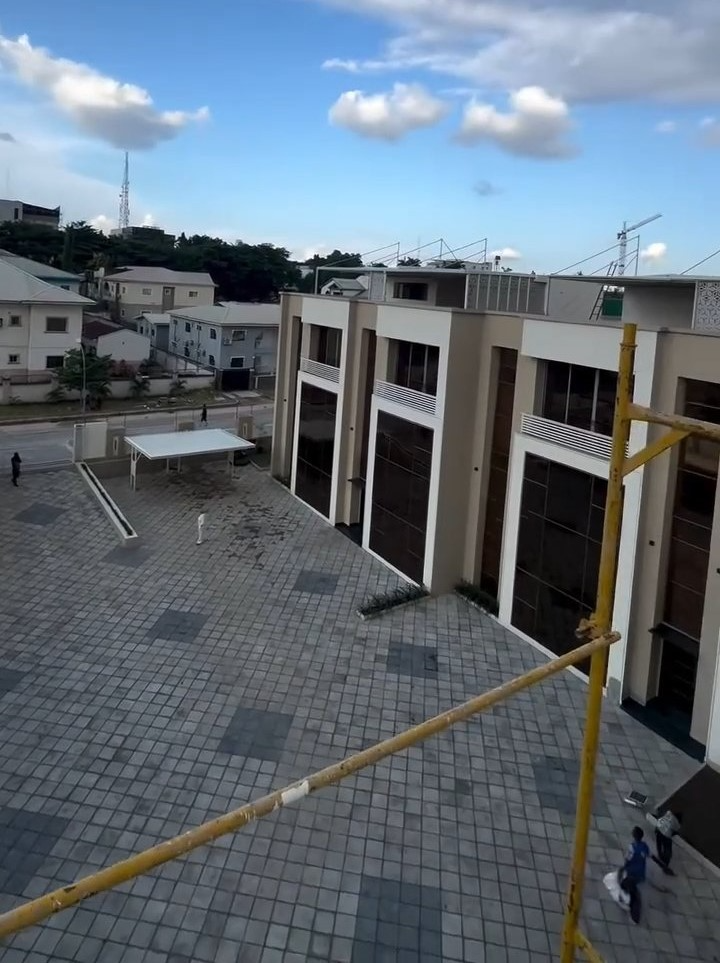 An aerial view of a building with a yellow pole in front of it