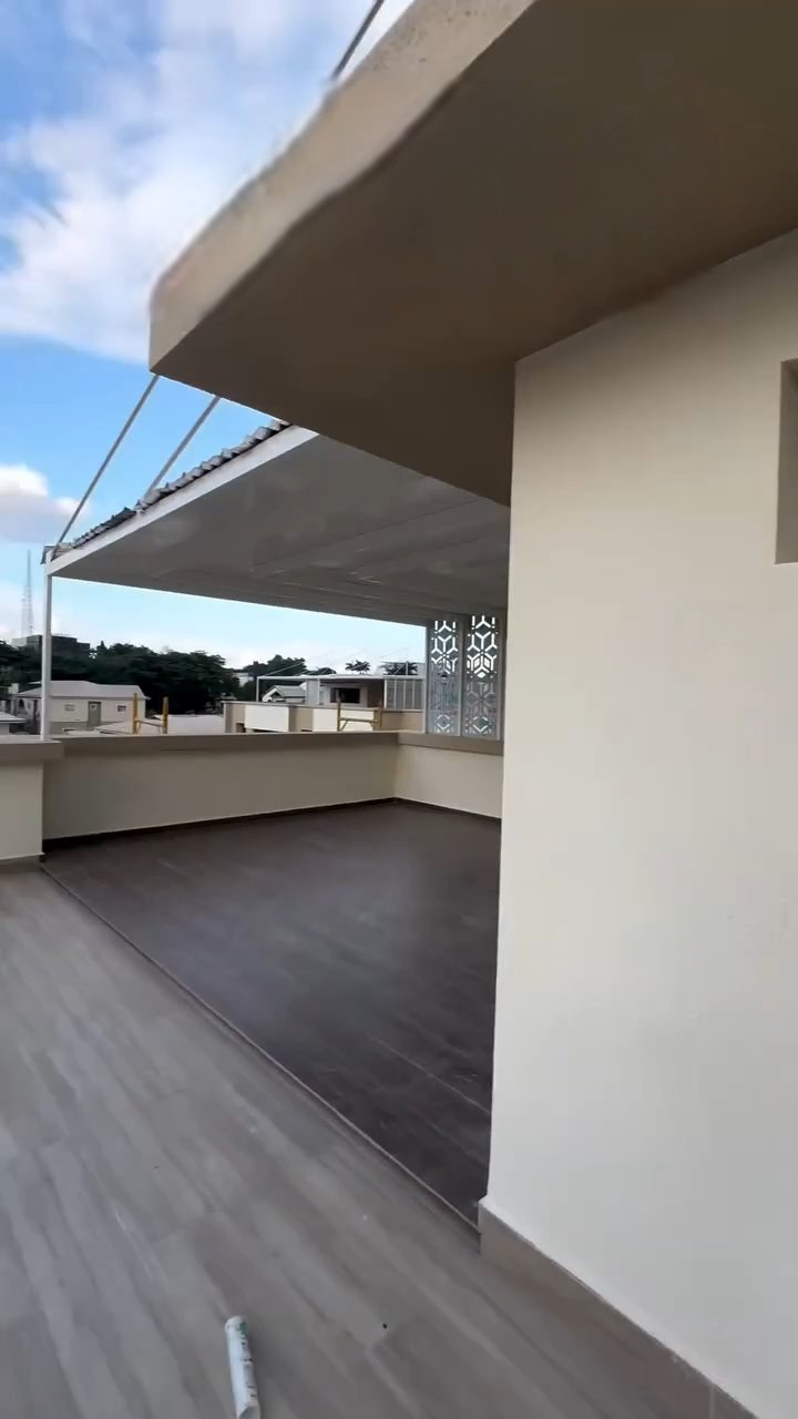 A balcony with a canopy over it and a wooden floor.