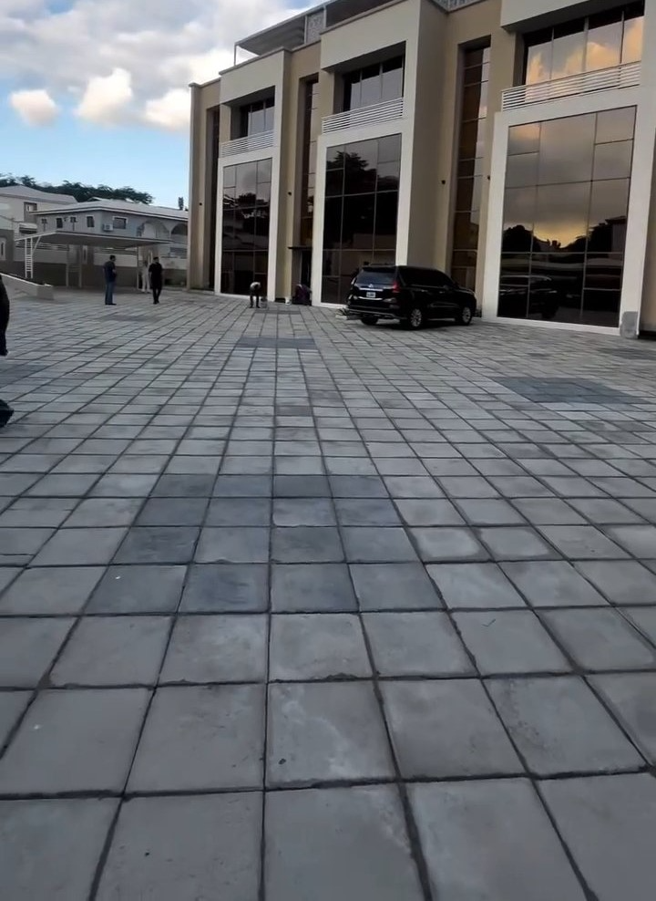 A large building with a car parked in front of it