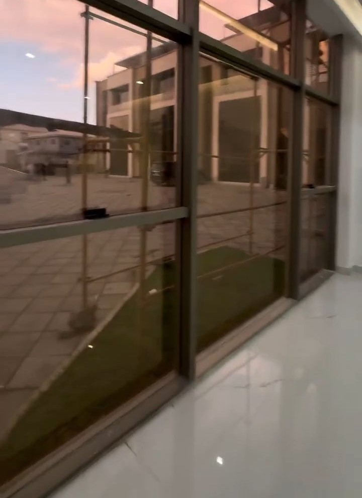 A hallway with a reflection of a building in the windows