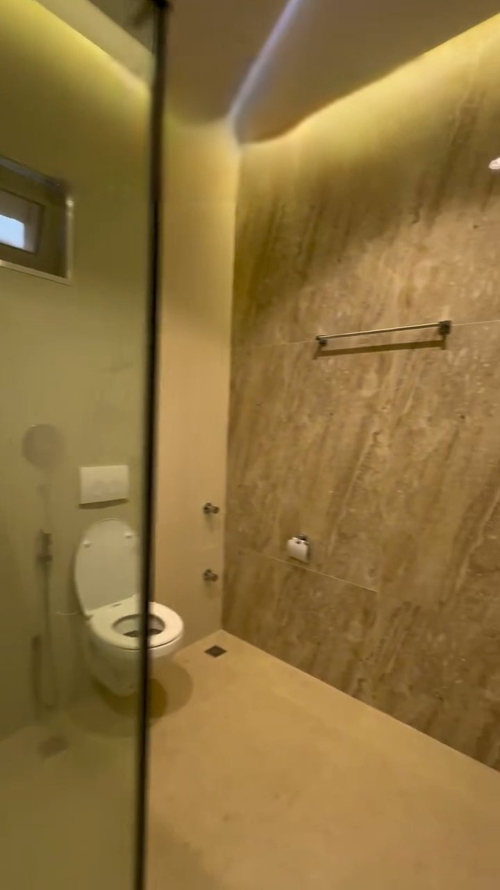 A bathroom with a toilet and a shower stall.
