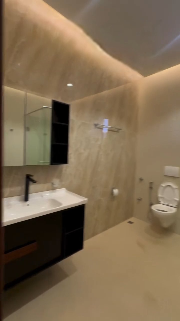 A bathroom with a sink , toilet and mirror