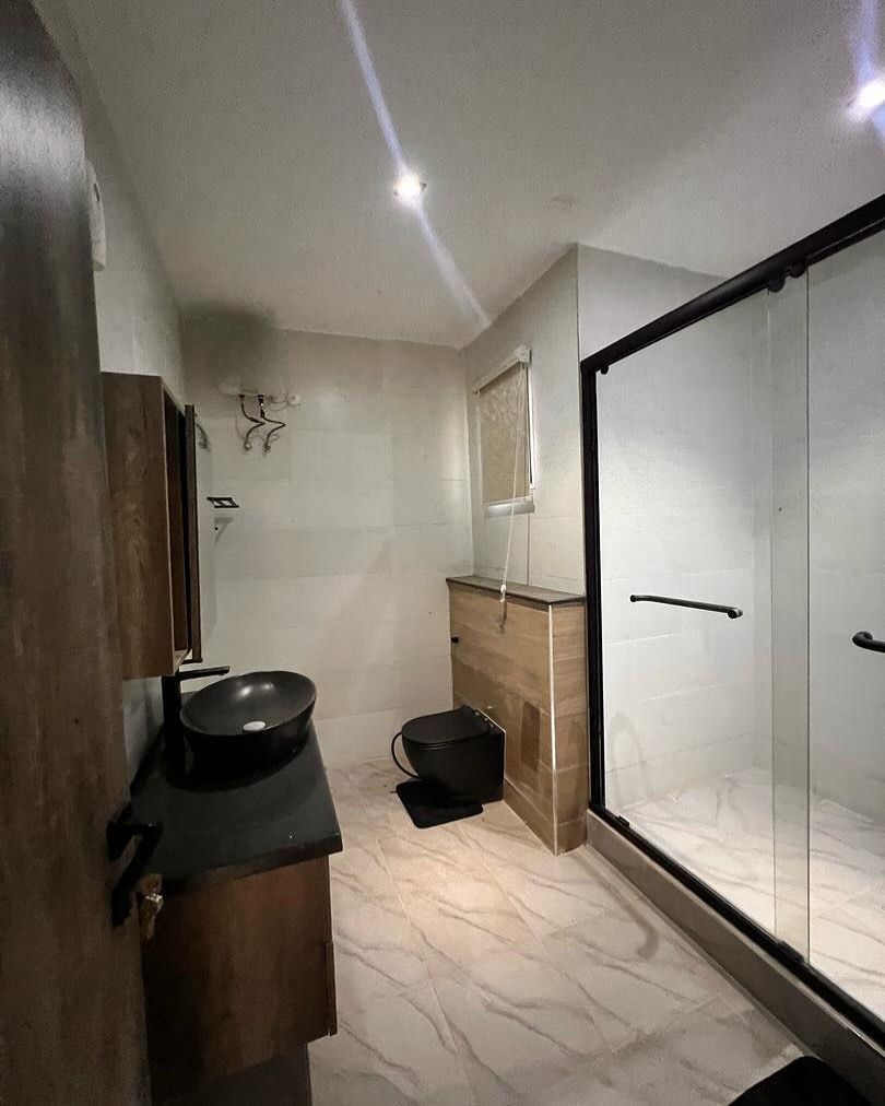A bathroom with a sink , toilet , and shower.