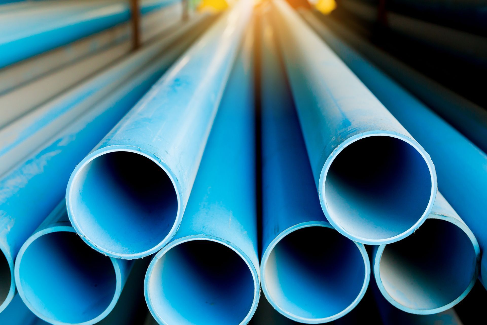 A close-up of a blue plastic pipe stacked at Madison Heights Plumbing & Heating Supply warehouse in Royal Oak, MI.