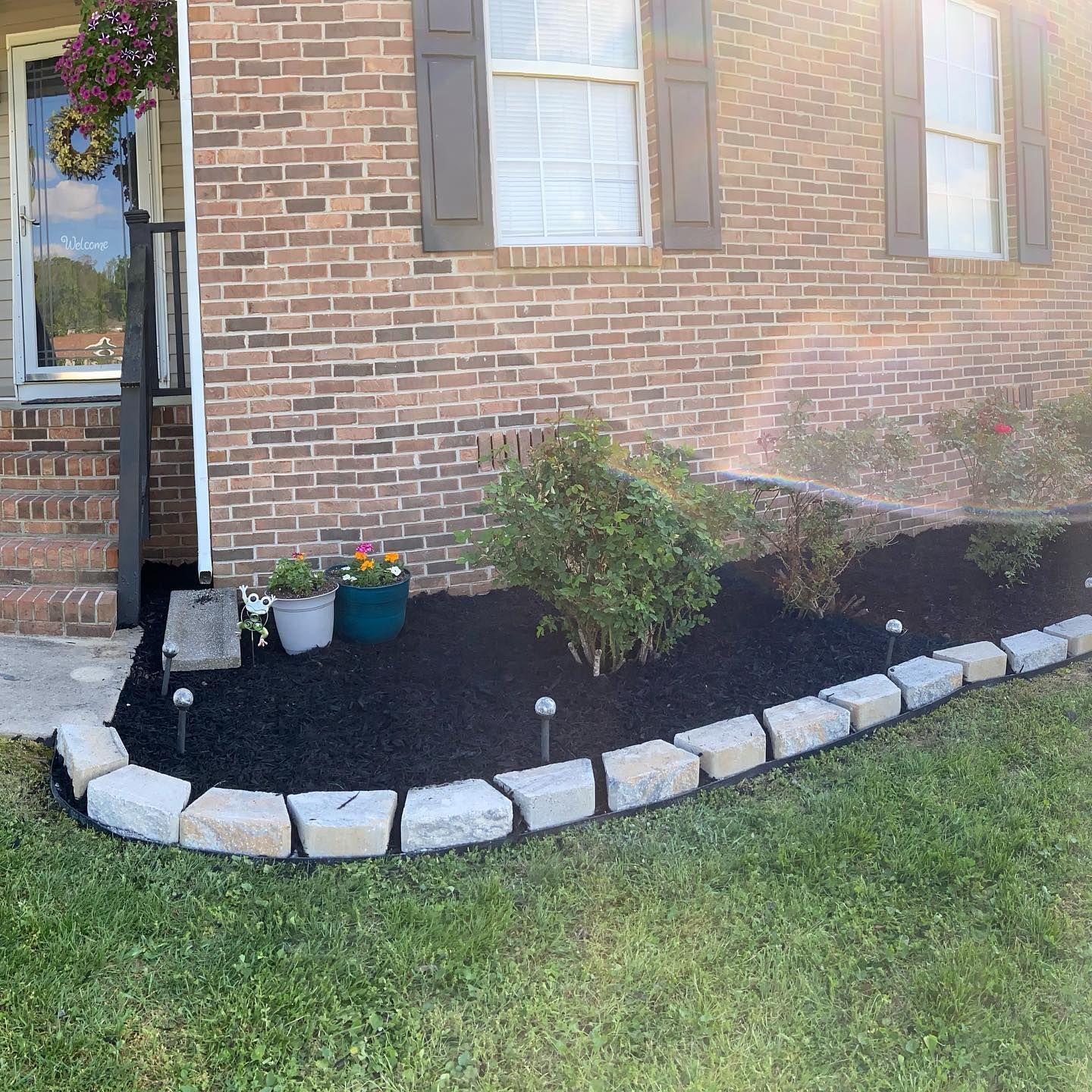 Landscape installation featuring mulch, plants, edging 