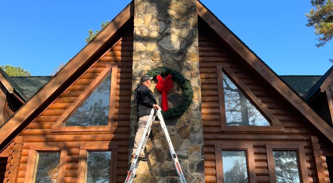 Holiday wreath installation on residential home