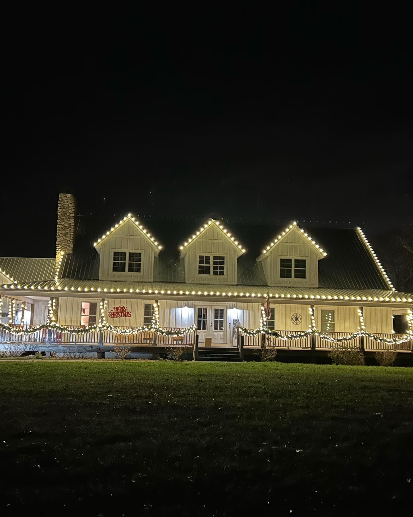 Professional Christmas lights installed along roofline and gutters