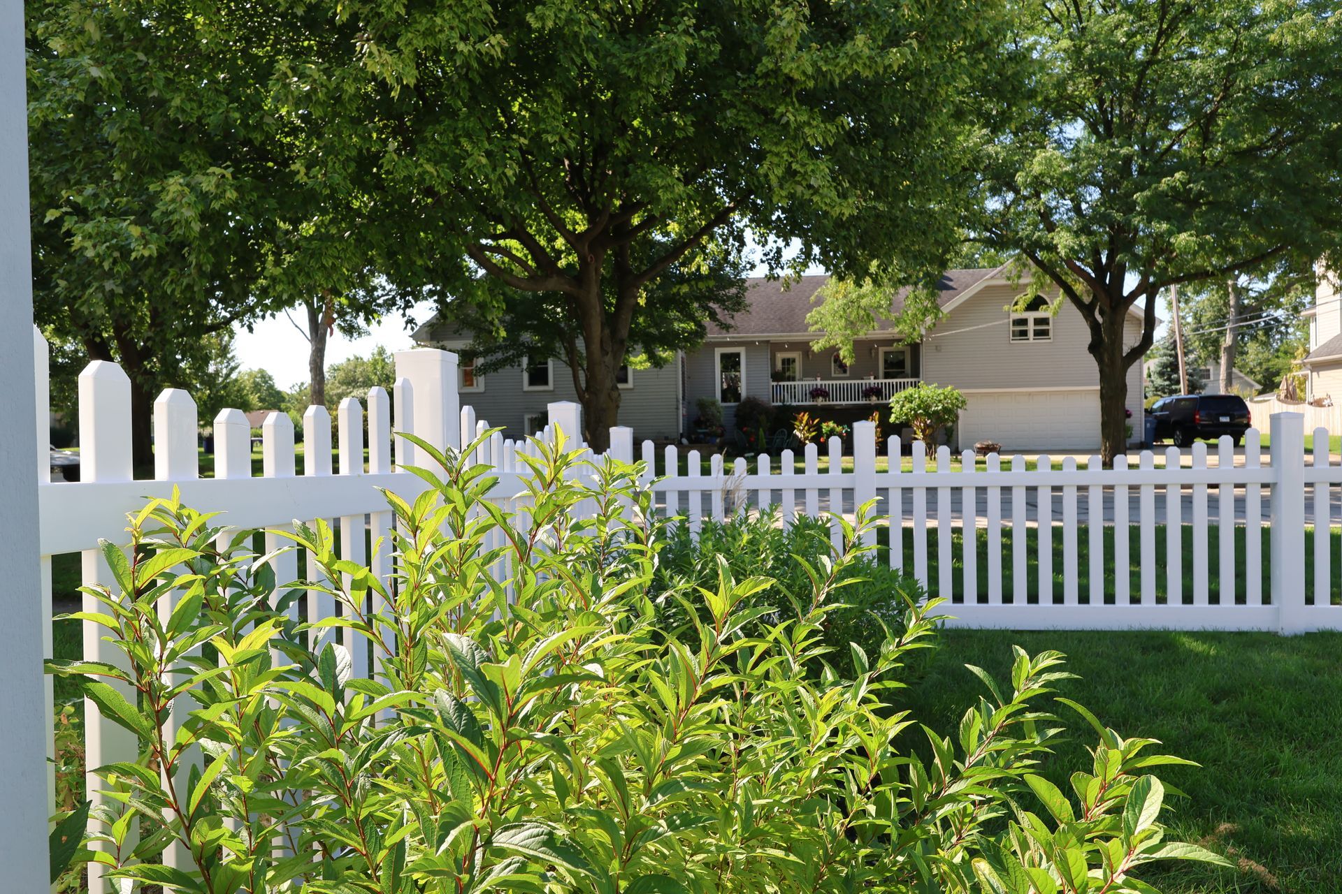 Licensed fence company team installing vinyl picket ornamental fence in Hoffman Estates IL