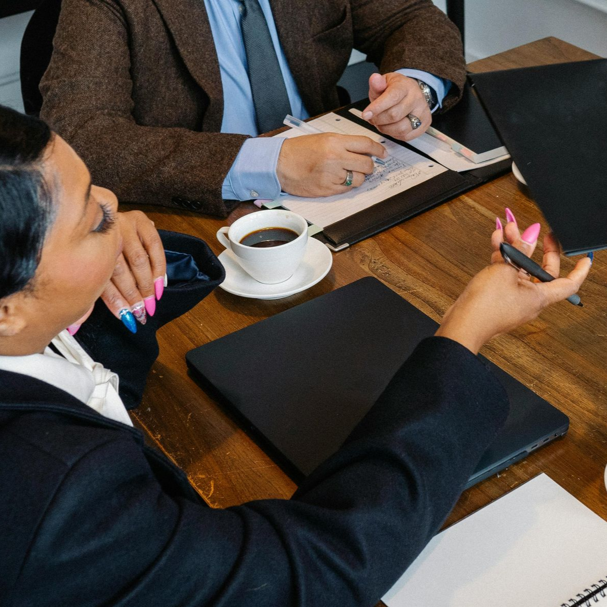 Business meeting with people reviewing documents around a table.