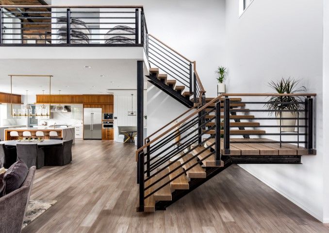 Modern Clearwater home with a stylish staircase, wood floors, and open kitchen