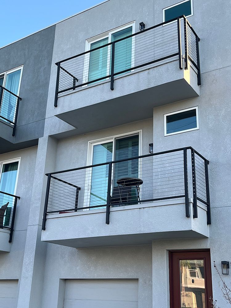 Modern two-story apartment with cable-railed balconies and garage