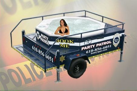 A hot tub on a trailer with a woman in a swimsuit. The trailer says 