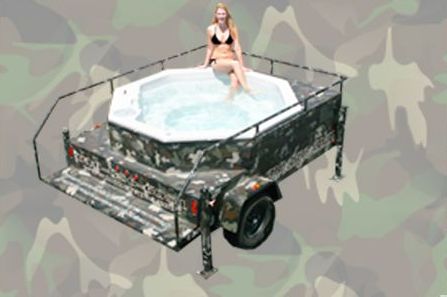 Woman in a bikini relaxing in a camo hot tub on a trailer.