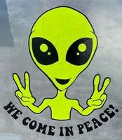 Green alien with large black eyes and peace signs, 