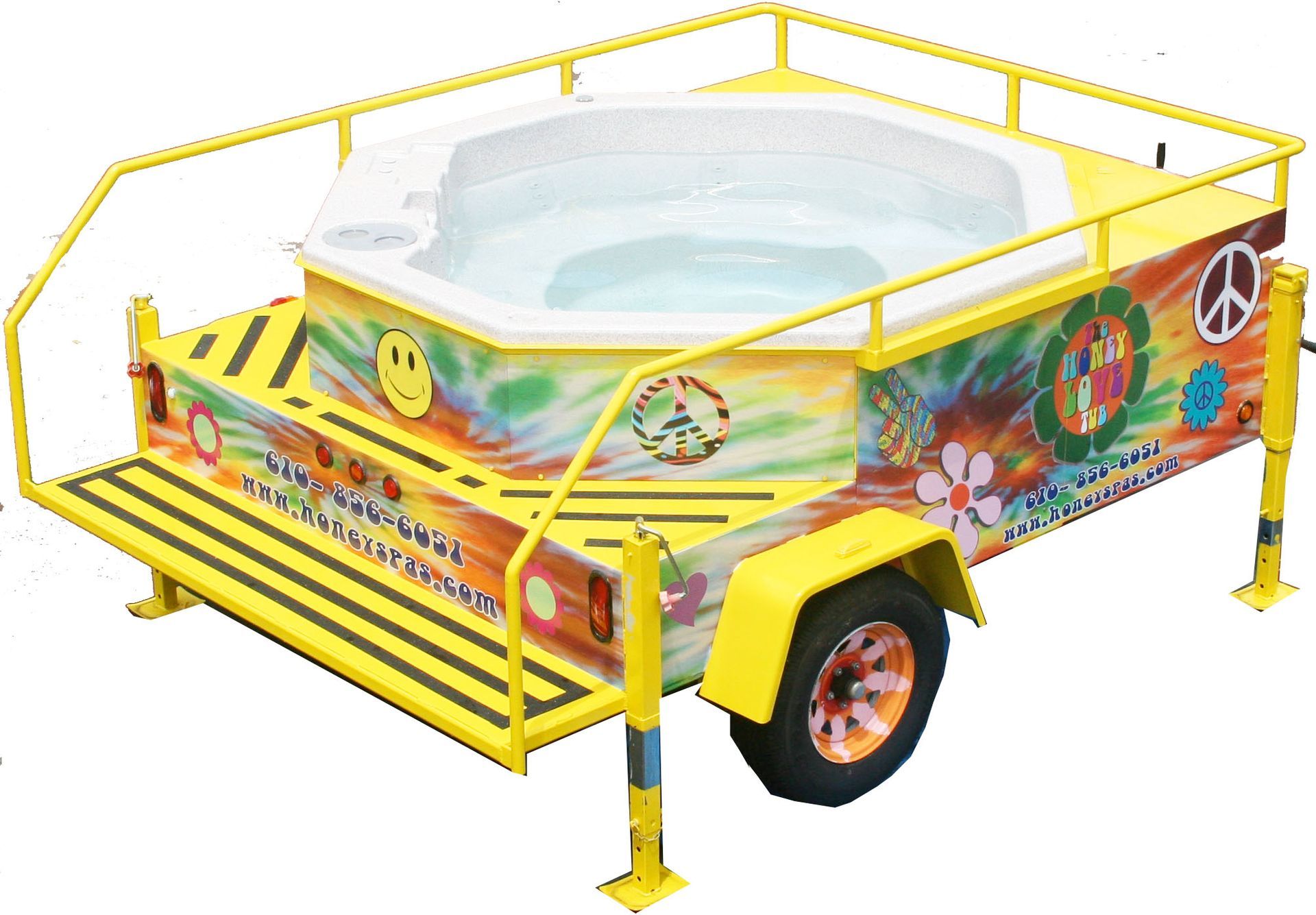 A yellow tie-dye trailer with a hot tub, peace signs, and smiley faces.