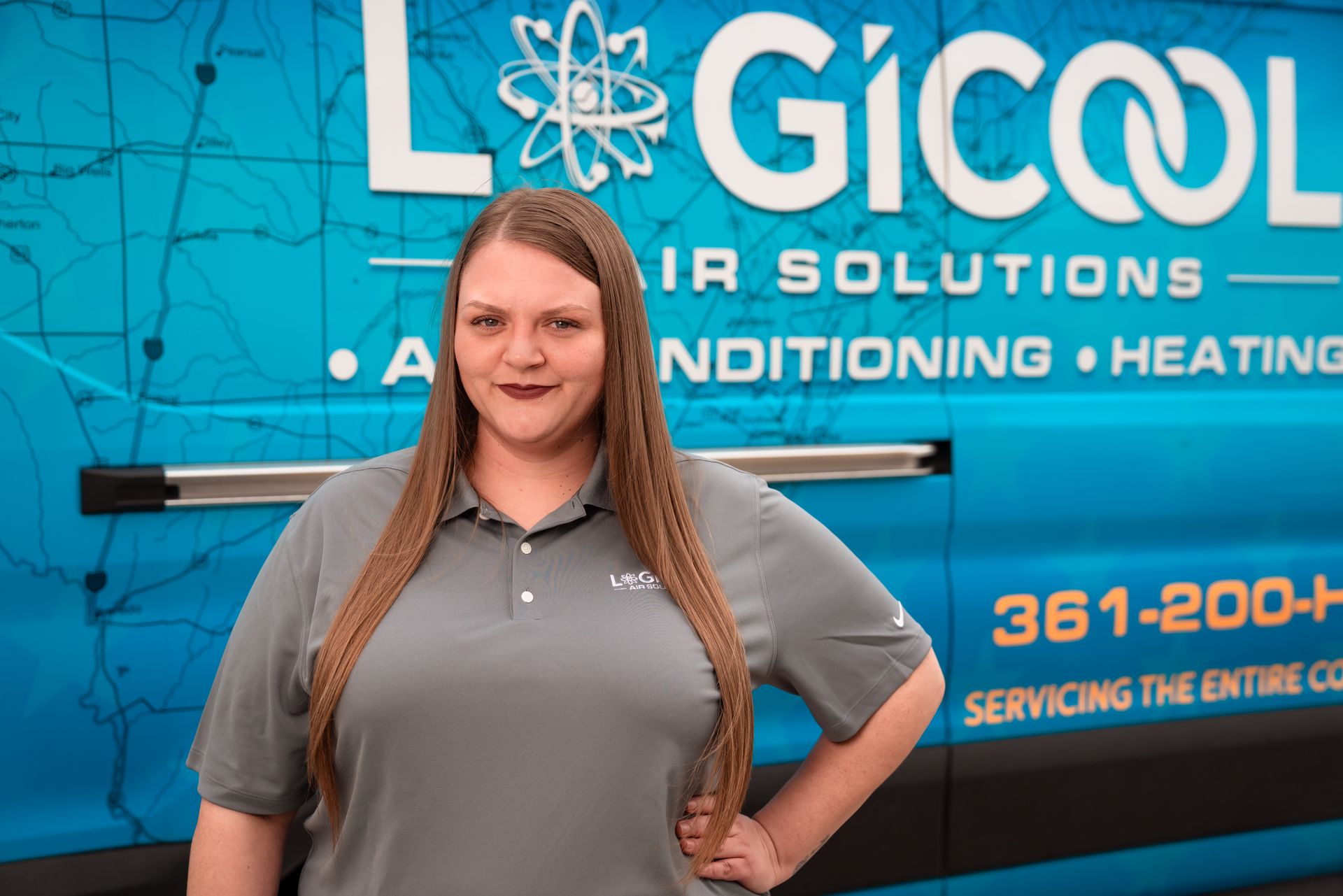 Woman standing in front of a blue HVAC company truck with “Logicool Air Solutions” branding.
